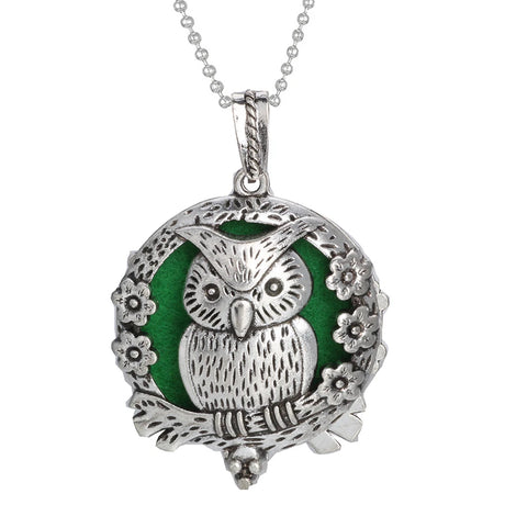 Silver owl pendant with green background on a white background