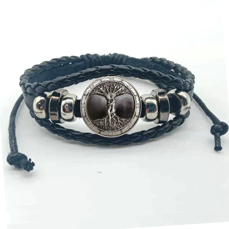 Black braided leather bracelet with silver tree of life charm on a white background