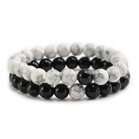Set of two beaded bracelets with black and white stones on a white background
