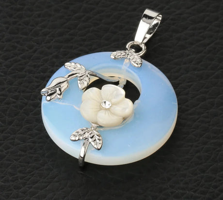 Jewelry pendant with floral design on a textured black background