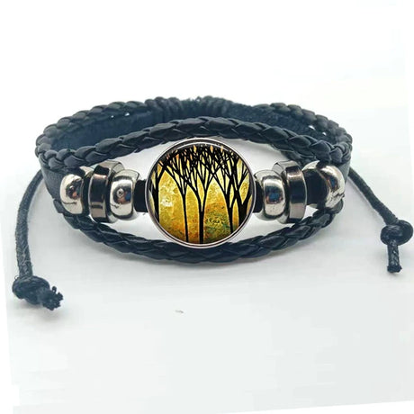 Bracelet with black braided strap and silver accents featuring a nature-themed design on a white background