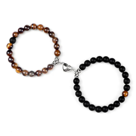 Two beaded bracelets, one with brown and black beads and the other with black beads, on a white background.