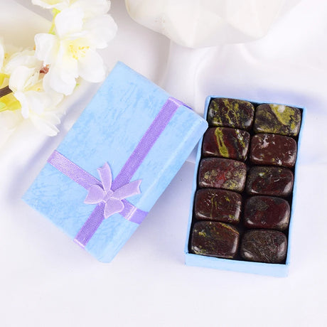 Box of chocolates with a decorative ribbon on a white background