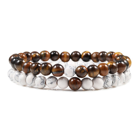 Two beaded bracelets with brown, black, and white stones on a white background