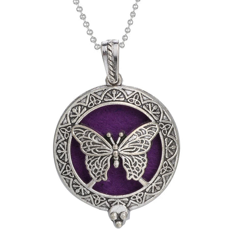 Silver butterfly pendant with intricate design on a purple background, on a white background