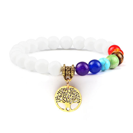 Bracelet with white beads and colorful beads featuring a gold tree of life charm on a white background