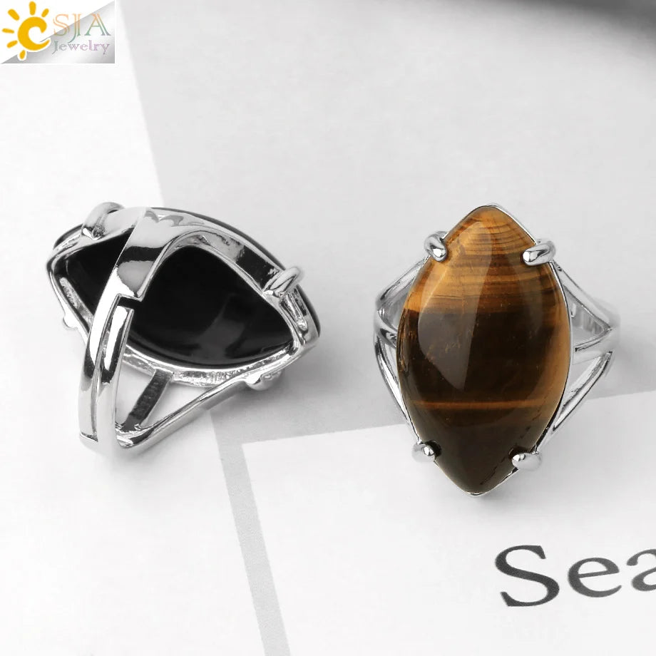 Two silver rings with gemstones on a white surface