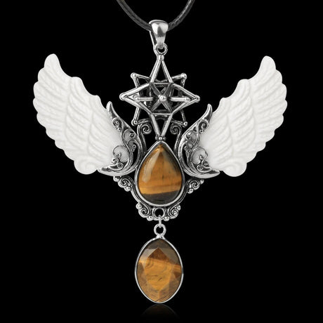 Jewelry pendant with wings and star design on a black background