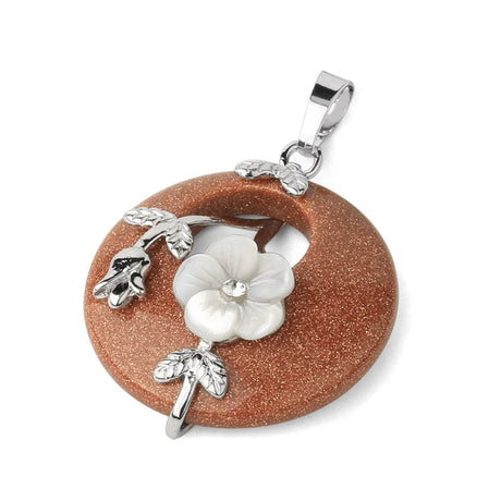 Jewelry pendant with floral design on a brown stone background