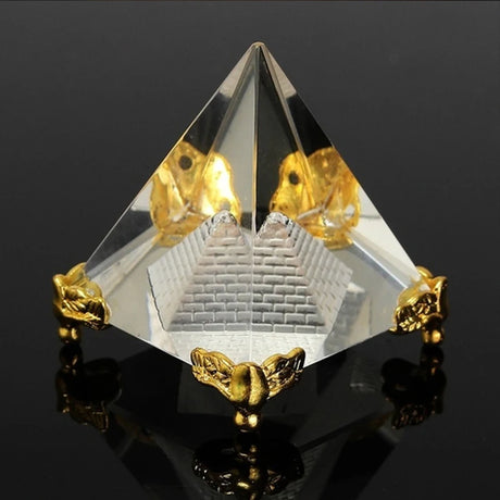 Crystal pyramid with gold accents on a black background