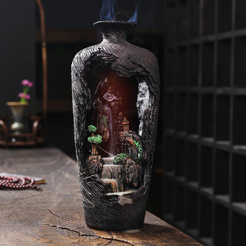 Decorative bottle with a miniature landscape inside, featuring trees and a waterfall.