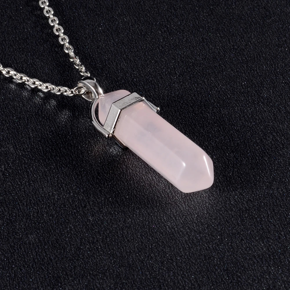 Necklace with a pink crystal pendant on a black background