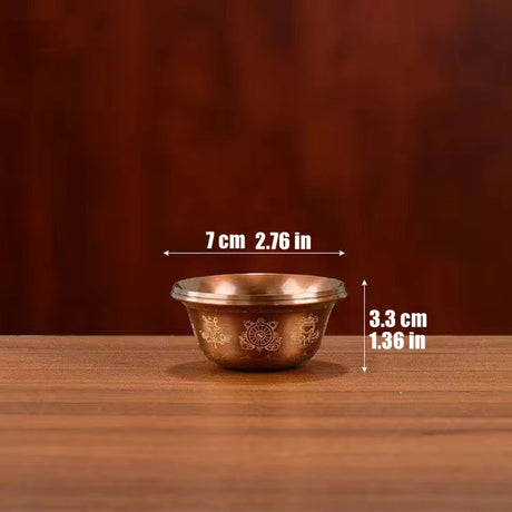 Small brass bowl with measurements on a wooden surface and brown background