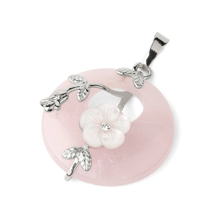 Pink stone pendant with silver floral design on a white background