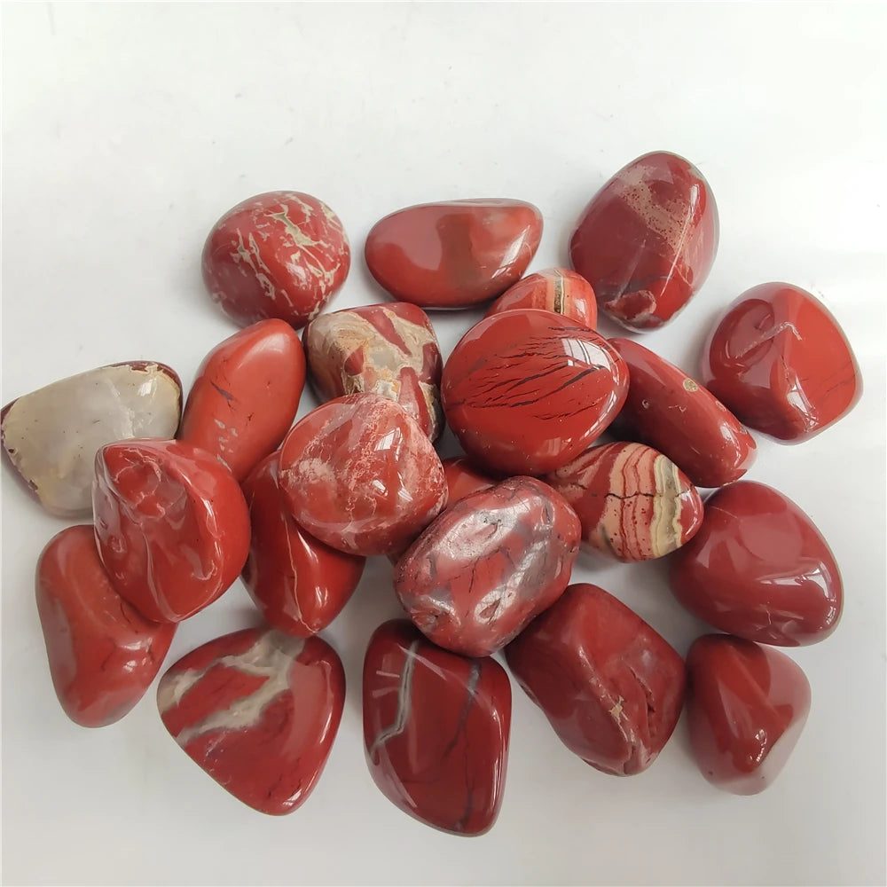 Collection of red marbled stones on a white background