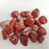 Collection of red marbled stones on a white background