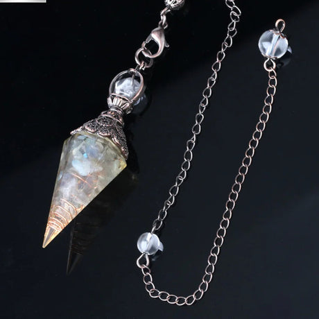 Crystal pendant with chain on a dark background, featuring the Cilia Jewelry logo.