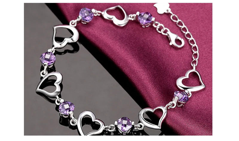 Silver bracelet with purple heart-shaped beads on a dark background, featuring ZDADAN branding.