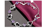 Silver bracelet with purple heart-shaped beads on a dark background, featuring ZDADAN branding.