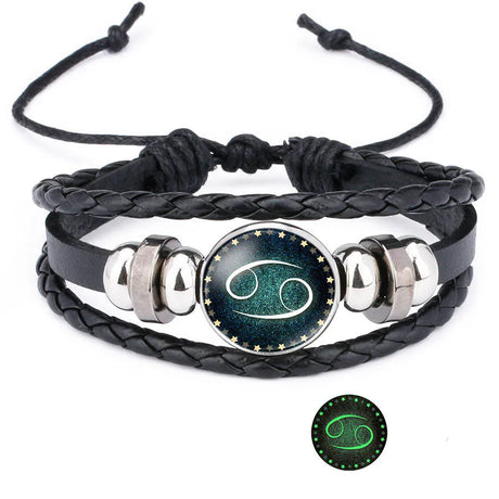 Black braided leather bracelet with silver accents and a Cancer zodiac symbol on a white background.