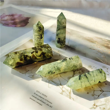 Green crystal formations on an open book with a blurred background