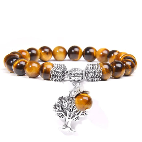 Bracelet with tiger eye beads and silver tree of life charm on a white background