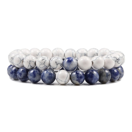 Stack of blue and white beaded bracelets on a white background