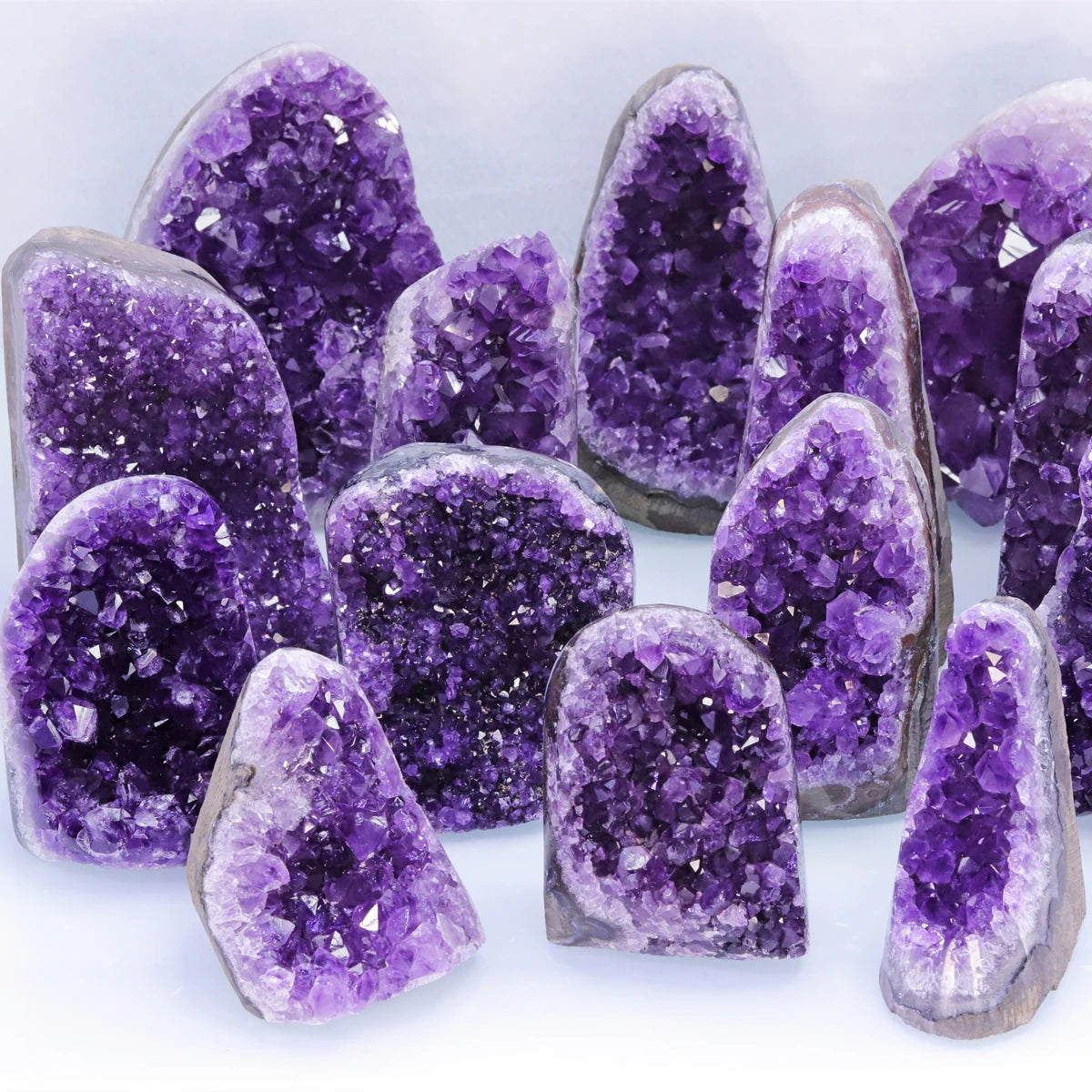 Collection of purple crystal formations on a white background