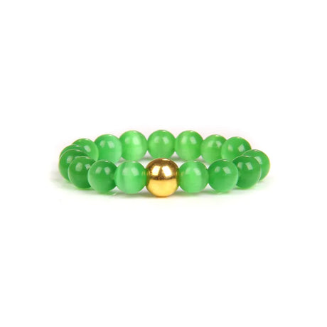 Green beaded bracelet with a gold accent on a white background