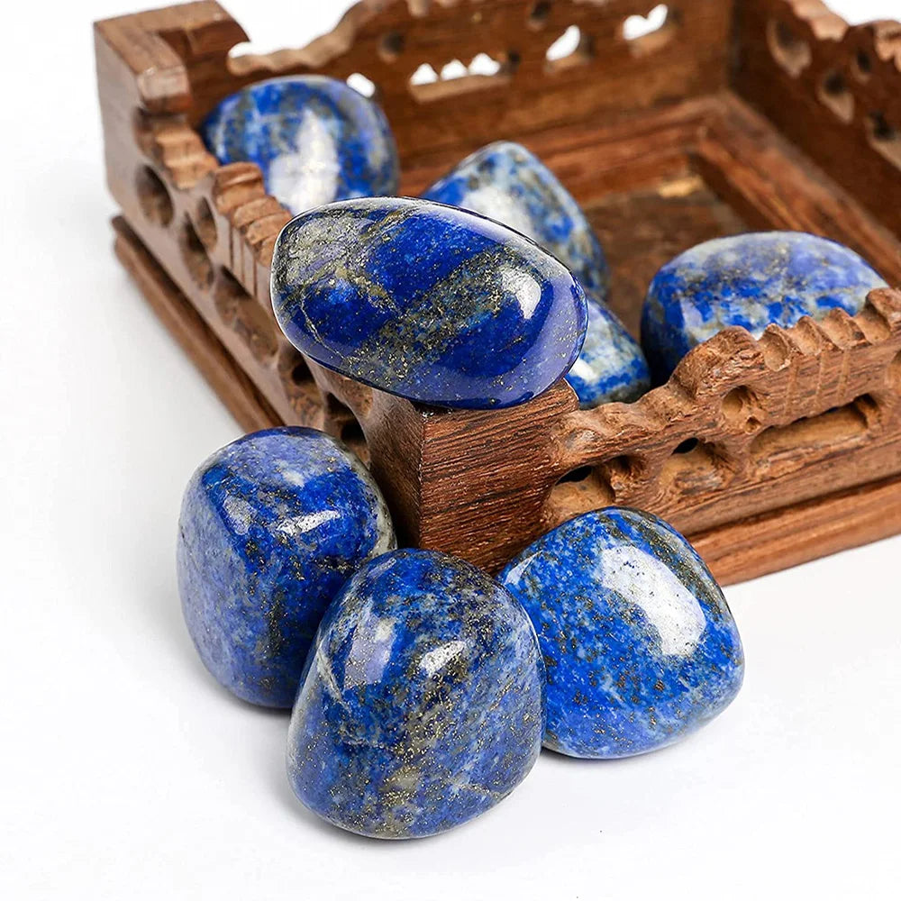Blue stones in a wooden decorative box on a white background