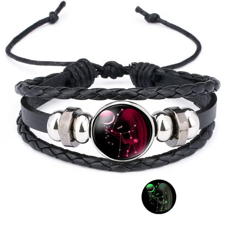 Black braided leather bracelet with a red and black circular pendant on a white background