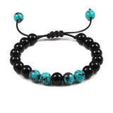 Black and turquoise beaded bracelet on a white background