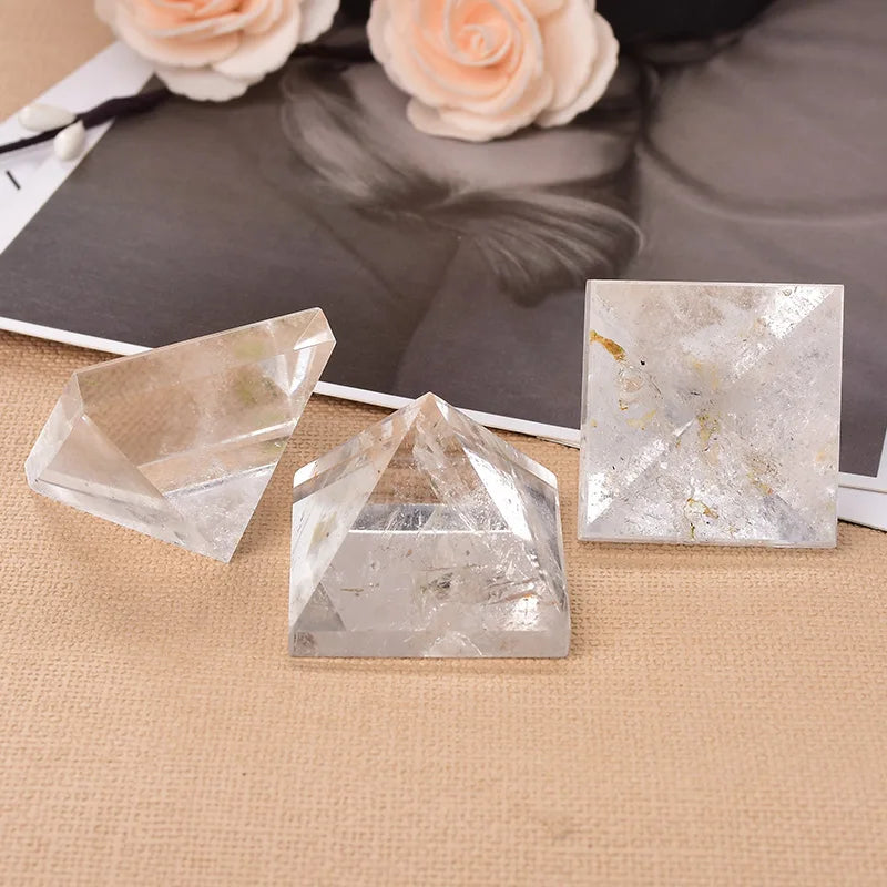 Crystal pyramids on a textured surface with flowers in the background