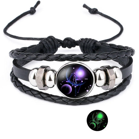 Black braided leather bracelet with a glowing astrological symbol charm on a white background