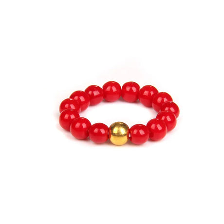 Red beaded bracelet with a gold accent on a white background
