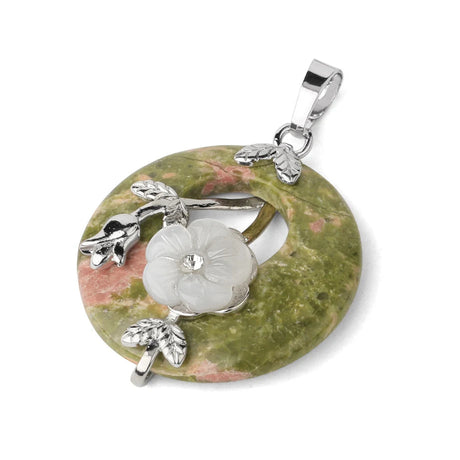 Jewelry pendant with floral design on a green stone background