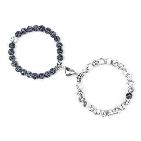 Two bracelets, one with black beads and the other with silver chain links, on a white background.