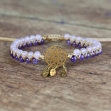 Beaded bracelet with gold charm on a wooden surface