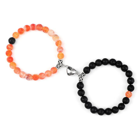 Two beaded bracelets, one with orange beads and the other with black beads, on a white background.
