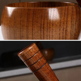 Close-up of a wooden cup and handle with visible grain and texture.