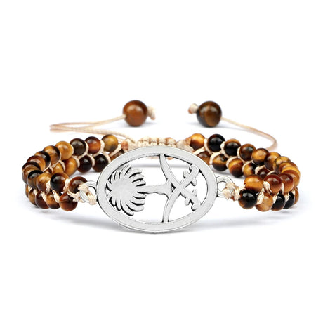 Bracelet with tiger eye beads and silver charm on a white background