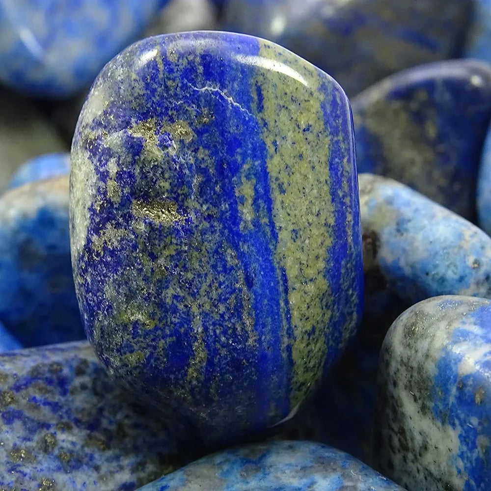 Close-up of a blue stone with a rough texture, surrounded by similar stones.