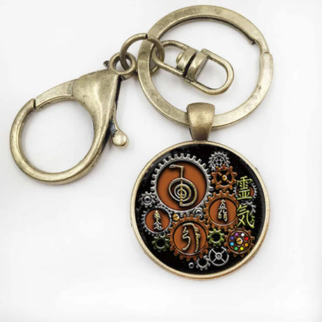 Keychain with circular pendant featuring intricate designs on a white background