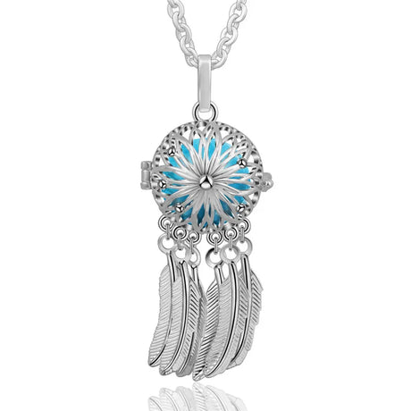 Silver dreamcatcher pendant with blue center and feathers on a white background