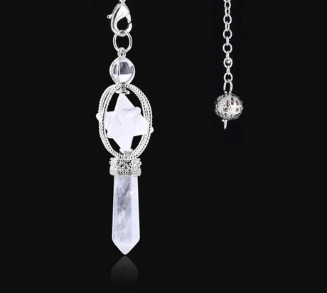 Silver pendant with crystal on a black background