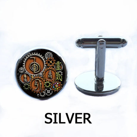 Silver cufflinks with intricate design on a white background
