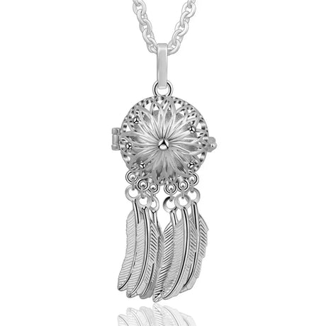 Silver dreamcatcher pendant with feathers on a white background