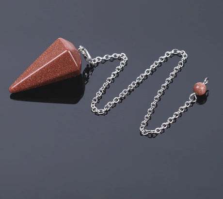 Brown stone pendulum on a chain with a dark background