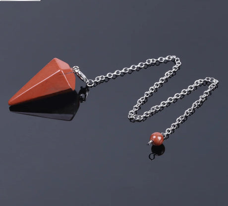 Necklace with red stone pendant on a dark background