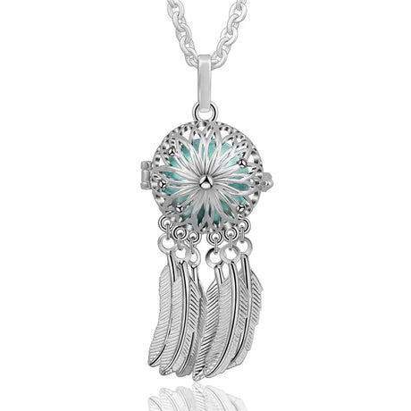 Silver necklace with a turquoise center and feather charms on a white background